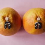 Oranges are pierced with wiggling earrings