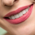 Shinny diamon white teeth of a woman with pink lips